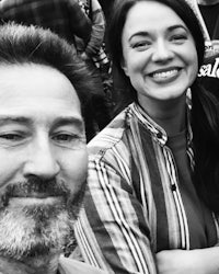 a black and white photo of a man and woman smiling